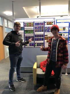 Current RAP students Tyler Drummond and Jarrett Childress pose in front of a research poster during an HONR-297 class assignment.